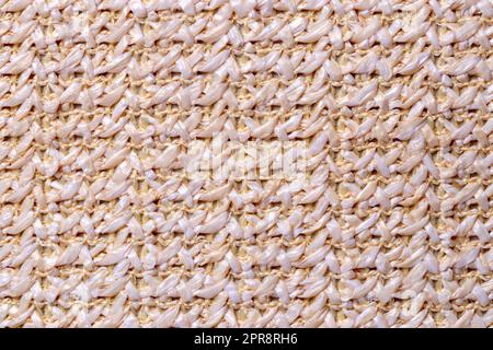 Polyester background texture. Close-up of colorful beige white synthetic fiber pattern for textile, bags  or other garments. Macro. Stock Photo