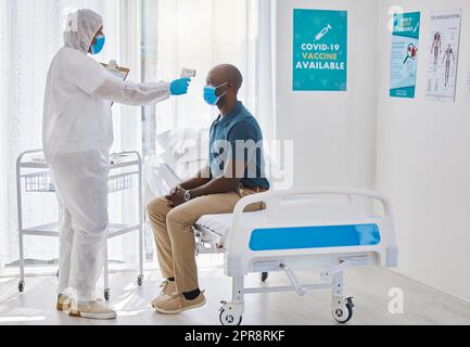 https://l450v.alamy.com/450v/2pr8rkf/medical-doctor-using-thermometer-to-scan-the-temperature-of-a-patient-african-american-patients-having-their-temperature-scanned-doctor-checking-a-patient-temperature-for-covid-symptoms-2pr8rkf.jpg