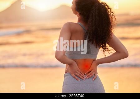 My back wasnt ready. a woman experiencing back pain during her workout. Stock Photo