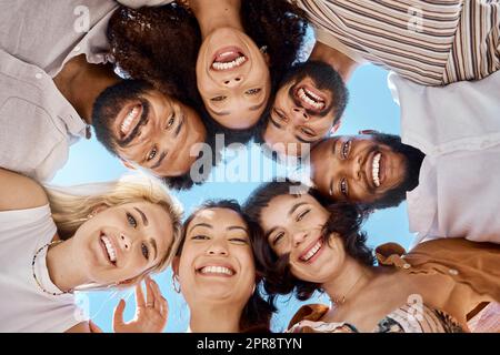 Friendship isnt a big thing, its a million little things. a group of friends standing together in a huddle. Stock Photo