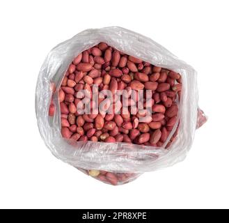 raw peanuts in a cellophane bag on a white background. Stock Photo