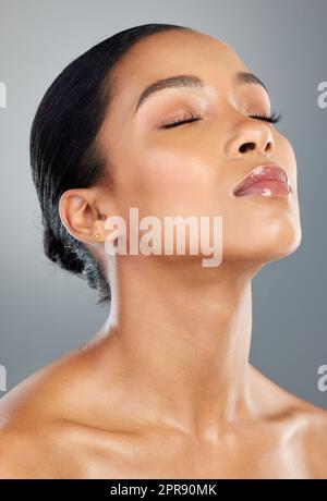 Be comfortable in your own skin. a beautiful young woman posing against a grey background. Stock Photo