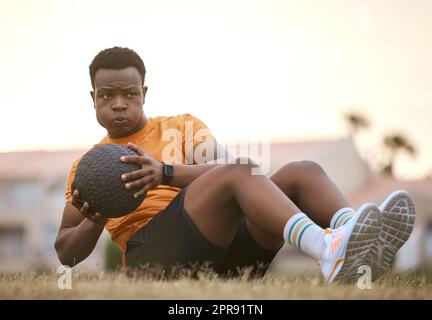 Serious african american athlete lifting dumbbell in tricep curl