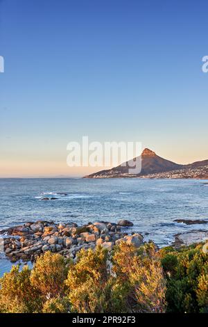 Seascape view of the majestic ocean with Lions Head mountain in the background. Beautiful calm sea and mountains with a blue sky background and copy space. Stunning nature and wilderness landscape Stock Photo