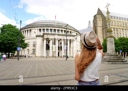 Traveler girl walking in St Peter square in Manchester City, United Kingdom Stock Photo