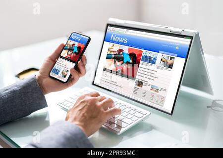 Watching News On Screen. Reading Newspaper Website Stock Photo
