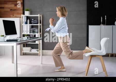 Squat Employee Doing Bulgarian Split Squat Exercise Stock Photo