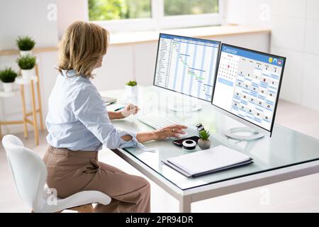 Employee Using Schedule Calendar Stock Photo