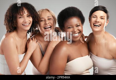 Were taking beauty to the next level. a diverse group of women standing and hugging each other in the studio. Stock Photo