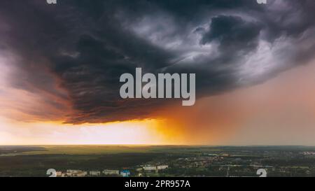 Stormy Sunset Sky Before Rain Above Skyline. Dramatic Cloudy Sky And Flash Light Stock Photo