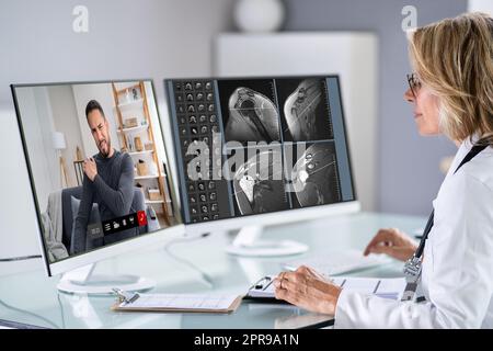 Online Video Conferencing. Physician looking Stock Photo