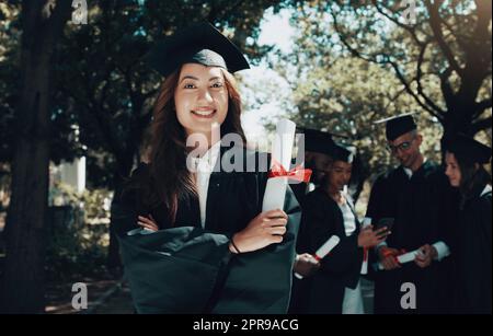 I dont know where Im going, but Im on my way. a student holding her diploma on graduation day. Stock Photo