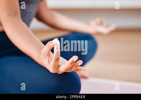Focusing my mind on whats important. an unrecognizable woman meditating at home. Stock Photo