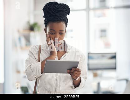I cant believe they did that. a businesswoman using her digital tablet at work. Stock Photo