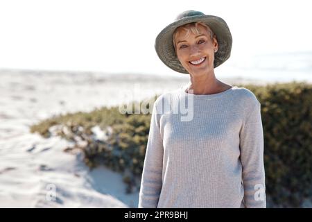 I love the beach. Cropped portrait of an attractive mature woman standing on the beach. Stock Photo