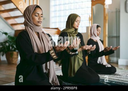 This has been a time of prosperity. a group of muslim women praying together. Stock Photo