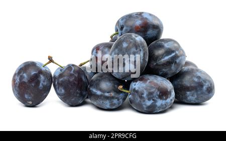 Stack of ripe blue plums on white isolated background Stock Photo