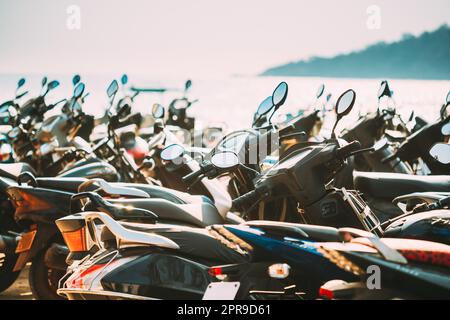 Motorbikes, motorcycles scooters parked in row in city street. Close up of details. Bikes Stock Photo