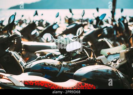 Motorbikes, motorcycles scooters parked in row in city street. Close up of details. Bikes Stock Photo