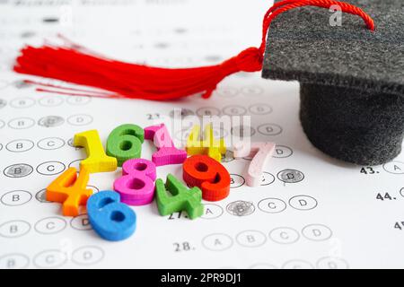 Math number with graduation gap hat on answer sheet test choice for learning Mathematic, education math concept. Stock Photo