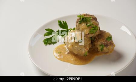 A plate of Swedish meatballs in cream sauce with mashed potato. Stock Photo