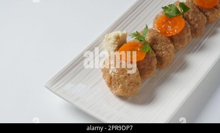 Traditional Jewish Passover food gefilte fish with carrots, horseradish, and lettuce Stock Photo