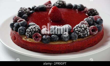 Berry jelly cake with frozen strawberries, blueberries, raspberries Stock Photo