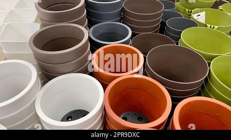 Close-up of empty flower pots in a store or greenhouse. Colorful pots for plants. Gardening and landscape design concept Stock Photo