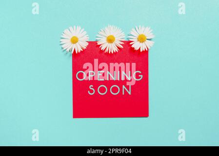 Writing displaying text Opening Soon. Business approach Going to be available or accessible in public anytime shortly Sticky Note With Important Messages With Three Flowers Above. Stock Photo