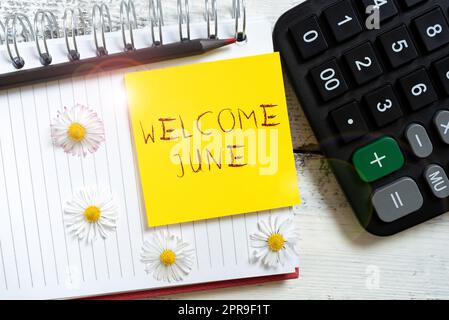 Writing displaying text Welcome June. Internet Concept Calendar Sixth Month Second Quarter Thirty days Greetings Note With Important Message Over Notebook With Flowers Around. Stock Photo