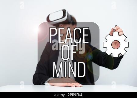 Inspiration showing sign Peace Of Mind. Concept meaning To be peaceful happy with things you have done and accomplish Businesswoman Wearing Virtual Reality Simulator And Holding Pen At Desk. Stock Photo
