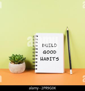 The words build good habits are standing on a notebook, change lifestyle, healthy and positive attidude, motivation concept Stock Photo