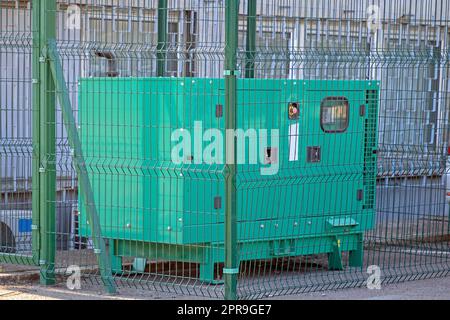 Emergency electric generator in cage Stock Photo