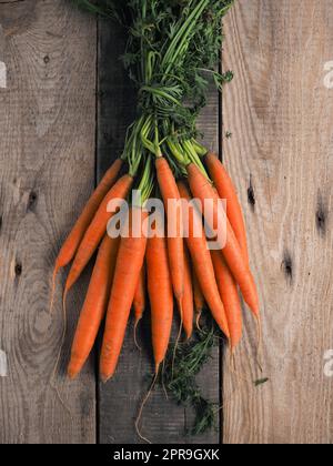 Tasty organic carrots on a rustic wooden table Stock Photo