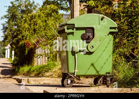 Green recycling container on the street Stock Photo