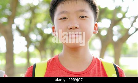 Portrait of happy  Asian boy outside the primary school Stock Photo