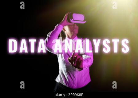Writing displaying text Data Analysts. Word for Programmer Design and Create Report Identifies patterns Woman Using Virtual Reality Simulator And Gesturing During Training. Stock Photo