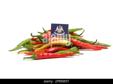 Mixed Color Fresh Cayenne Peppers With Flag of Louisiana Isolated on White Background Stock Photo