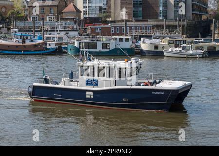 A Harbour Master boat from the Port of London Authority on the River Thames near the Old Deer Park, Richmond Park, London, UK. Stock Photo