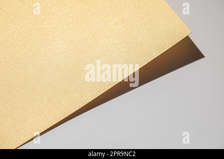 Golden cardbord on light gray background Stock Photo