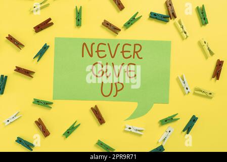 Hand writing sign Never Give Up. Business concept Keep trying until you succeed follow your dreams goals Colorful Pegs Placed Around Speech Bubble With Important Information. Stock Photo
