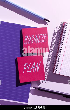 Conceptual display Business Plan. Word Written on Structural Strategy Goals and Objectives Financial Projections Important News Presented On Two Sticky Notes On Desk With Notebook And Pens Stock Photo