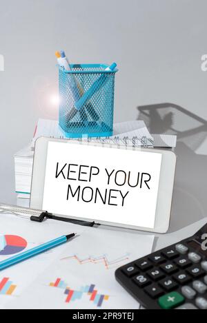 Text showing inspiration Keep Your Money. Internet Concept Save incomes for the future Invest financial balance Important Idea Shown On Phone On Desk With Cup With Pencils And Books. Stock Photo