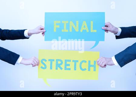 Text sign showing Final Stretch. Internet Concept Last Leg Concluding Round Ultimate Stage Finale Year ender Business Team Holding Two Important Ideas On Speech Bubbles On Both Sides. Stock Photo