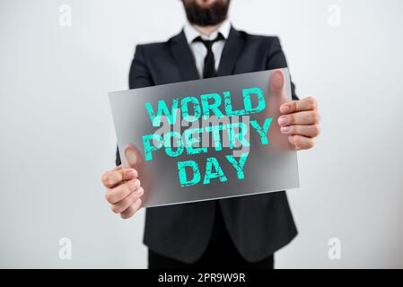 Hand writing sign World Poetry Day. Conceptual photo Worldwide literature celebration reading books time Male Professional Showing Placard And Advertising The Company. Stock Photo