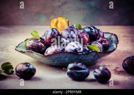 Freshly picked prune plums (Zwetschgen) fruits in bowl Stock Photo