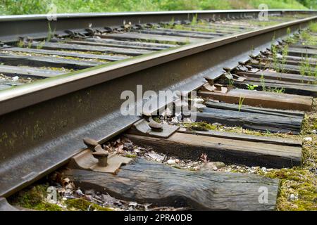 Old railroad track with wooden sleepers Stock Photo