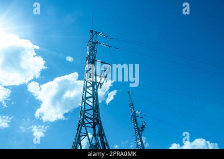 High voltage tower with electricity transmission power lines Stock Photo