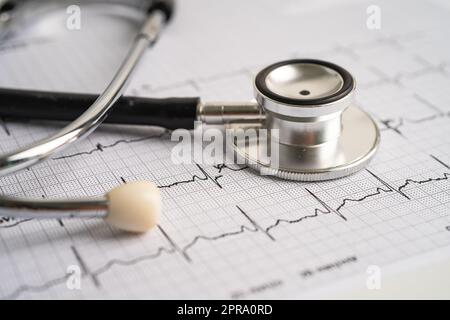 Stethoscope on electrocardiogram ECG, heart wave, heart attack, cardiogram report. Stock Photo