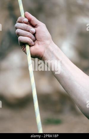 Hand holding a rock climbing rope Stock Photo